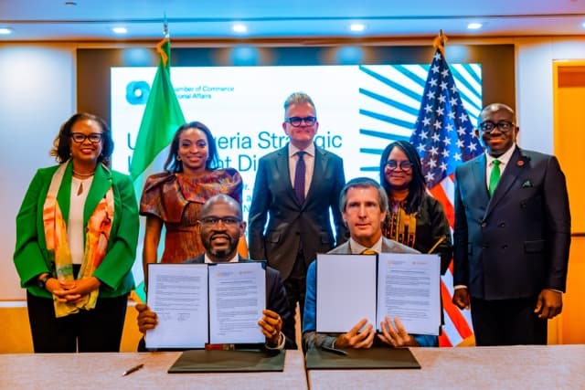 A wider view of the signing table, with the delegation assembled behind it
